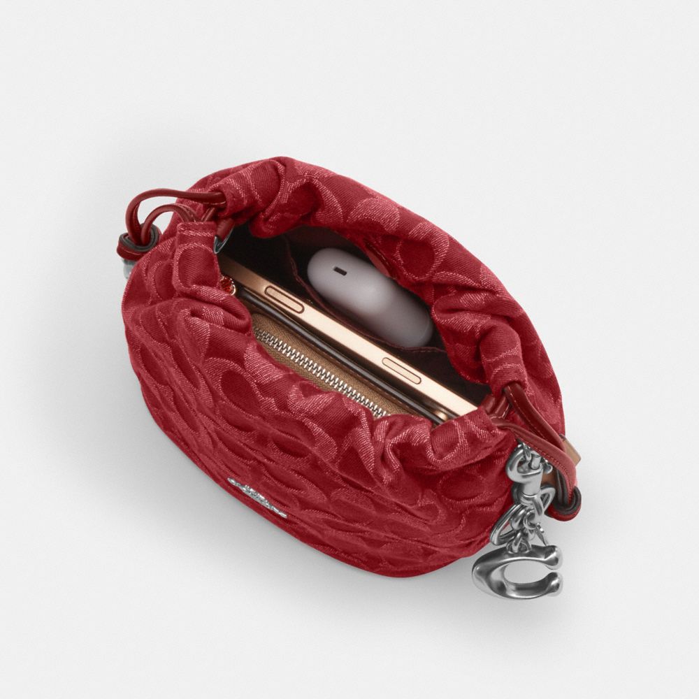 Coach Faye Mini Drawstring Bag In Signature Denim Silver True Red